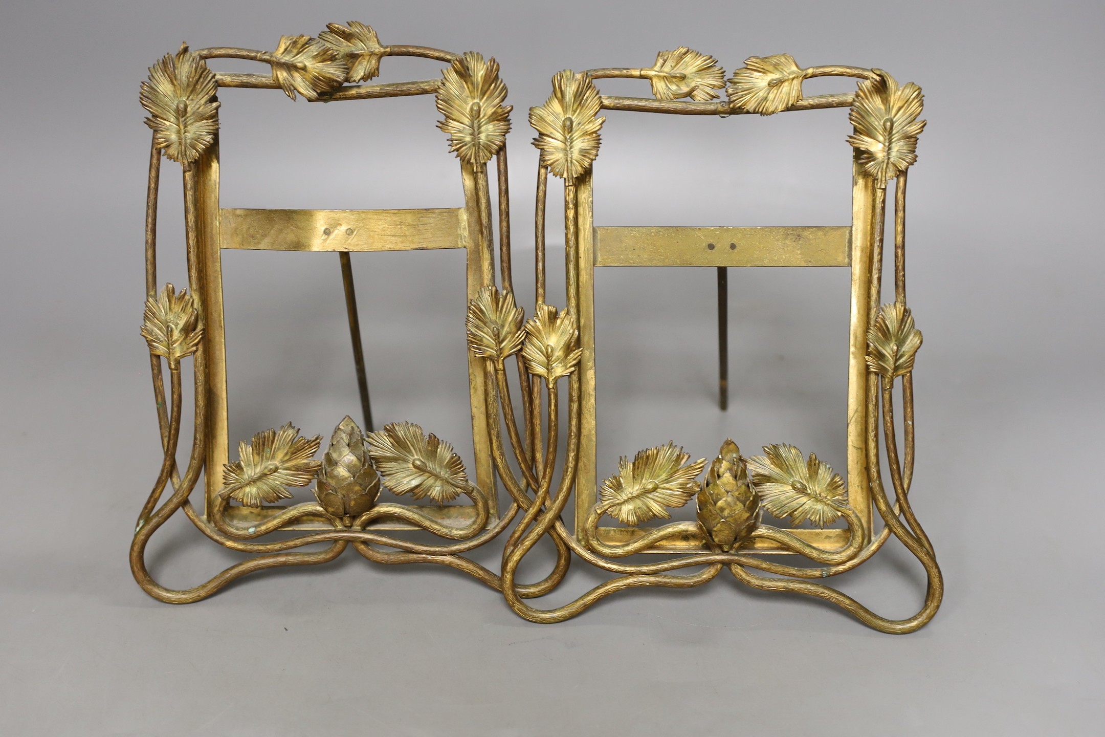 A pair of late 19th century brass photo frames, 20.5 cm high, and a pair of bronze furniture mounts